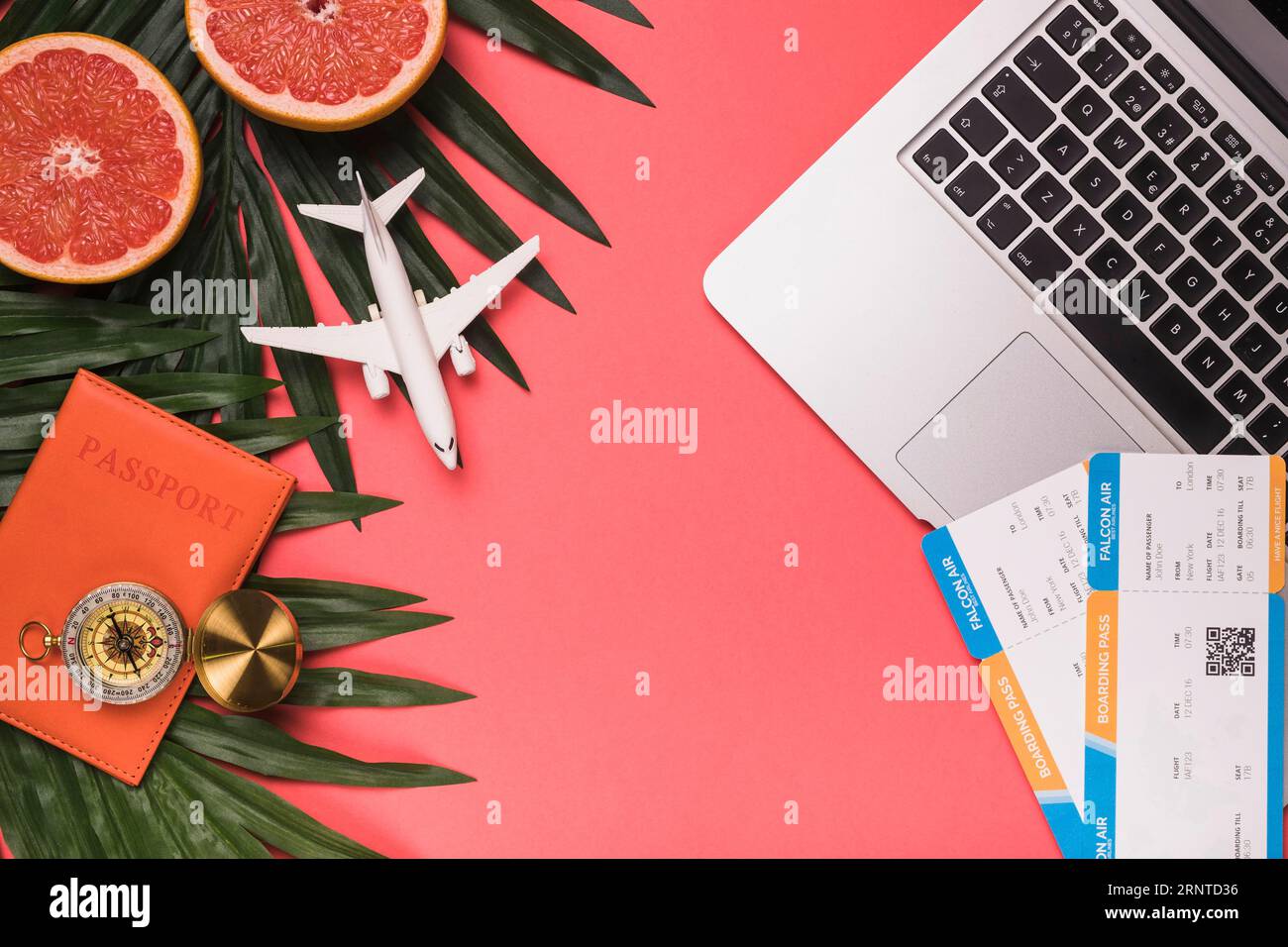 Composition small plane passport compass laptop tickets grapefruit plants leaves Stock Photo