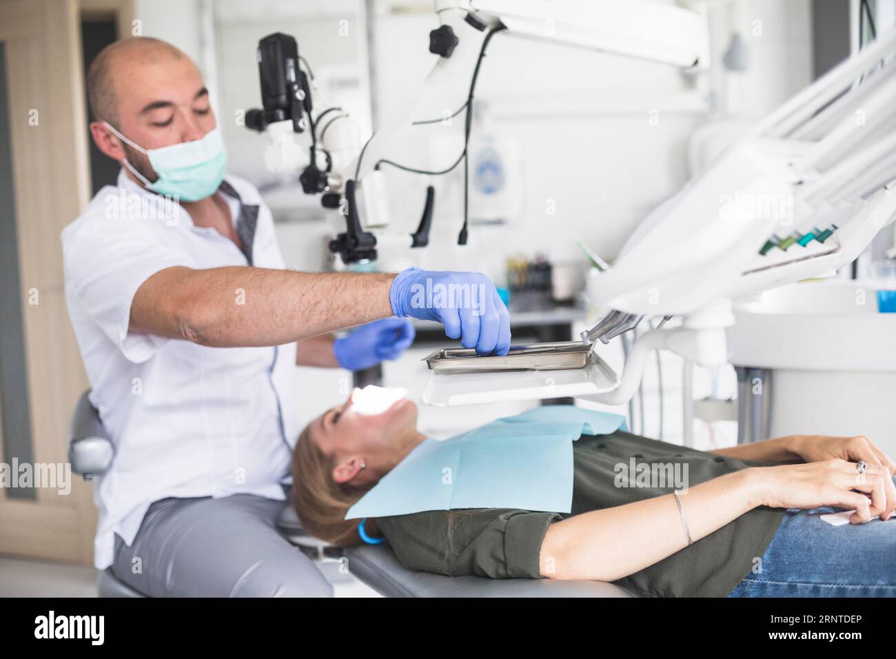 Dentist checking teeth woman lying dental chair Stock Photo Alamy