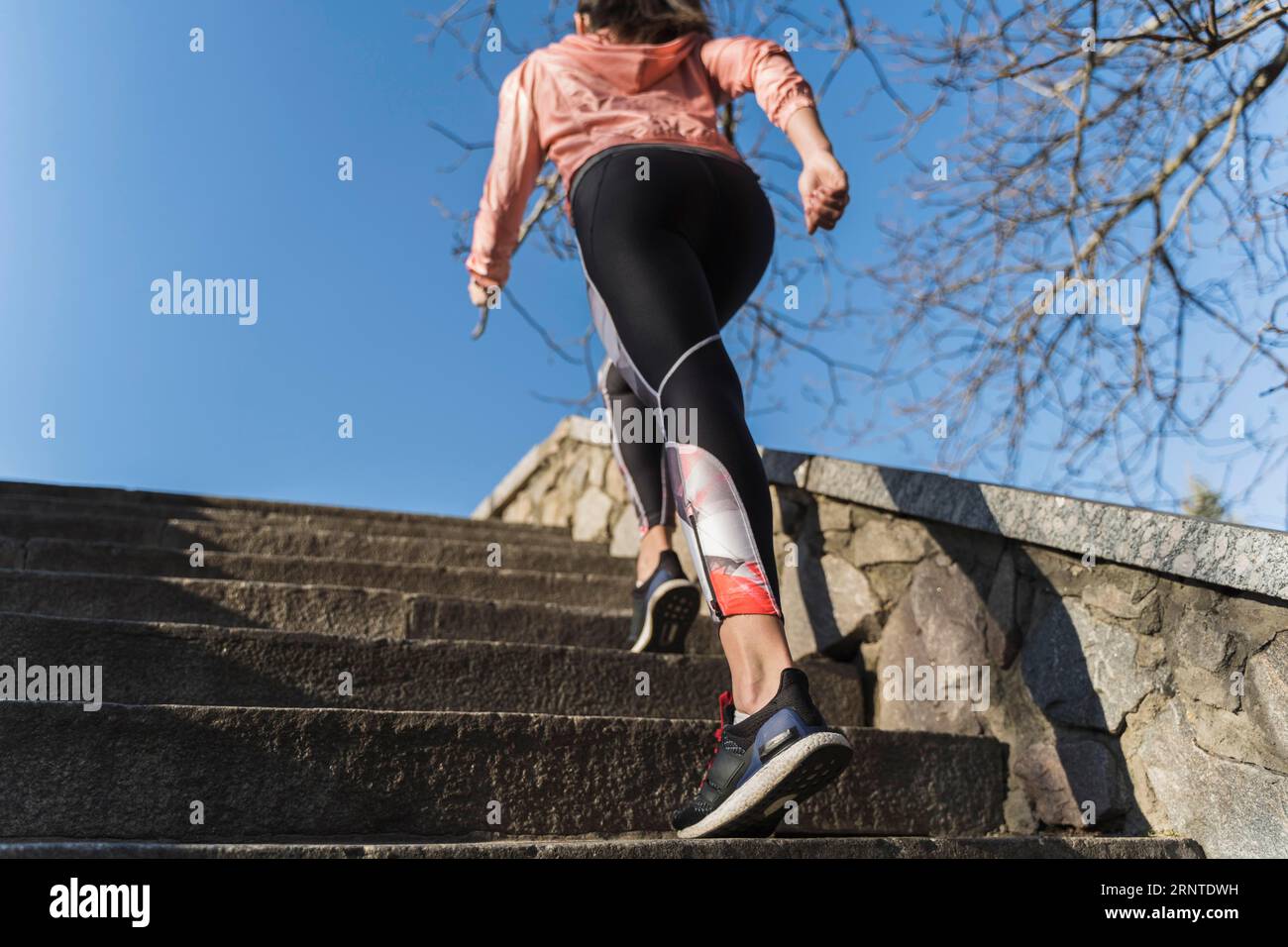 Fit young woman climbing stairs outdoor Stock Photo
