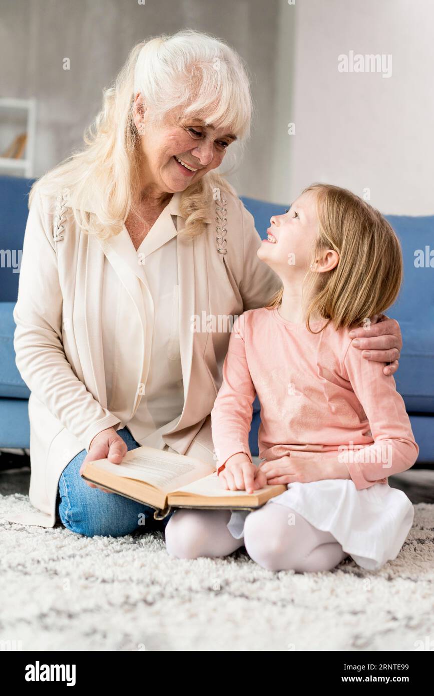 Grandma with girl reading Stock Photo