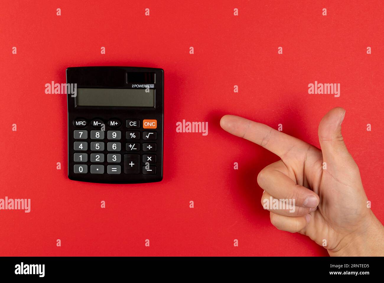 Hand pointing mini calculator Stock Photo