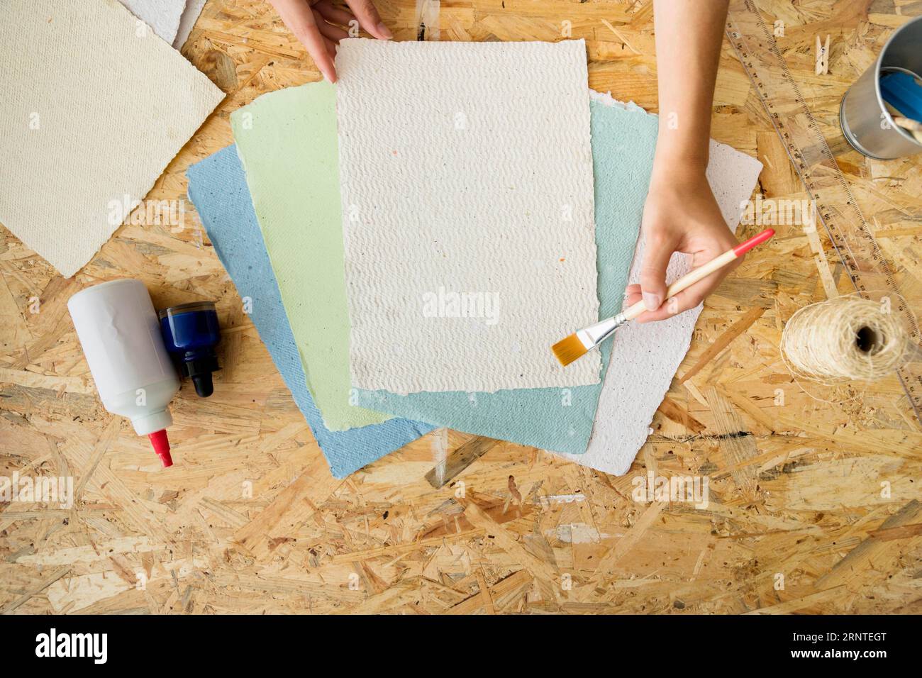 High angle view female s hand using paintbrush handmade papers Stock Photo