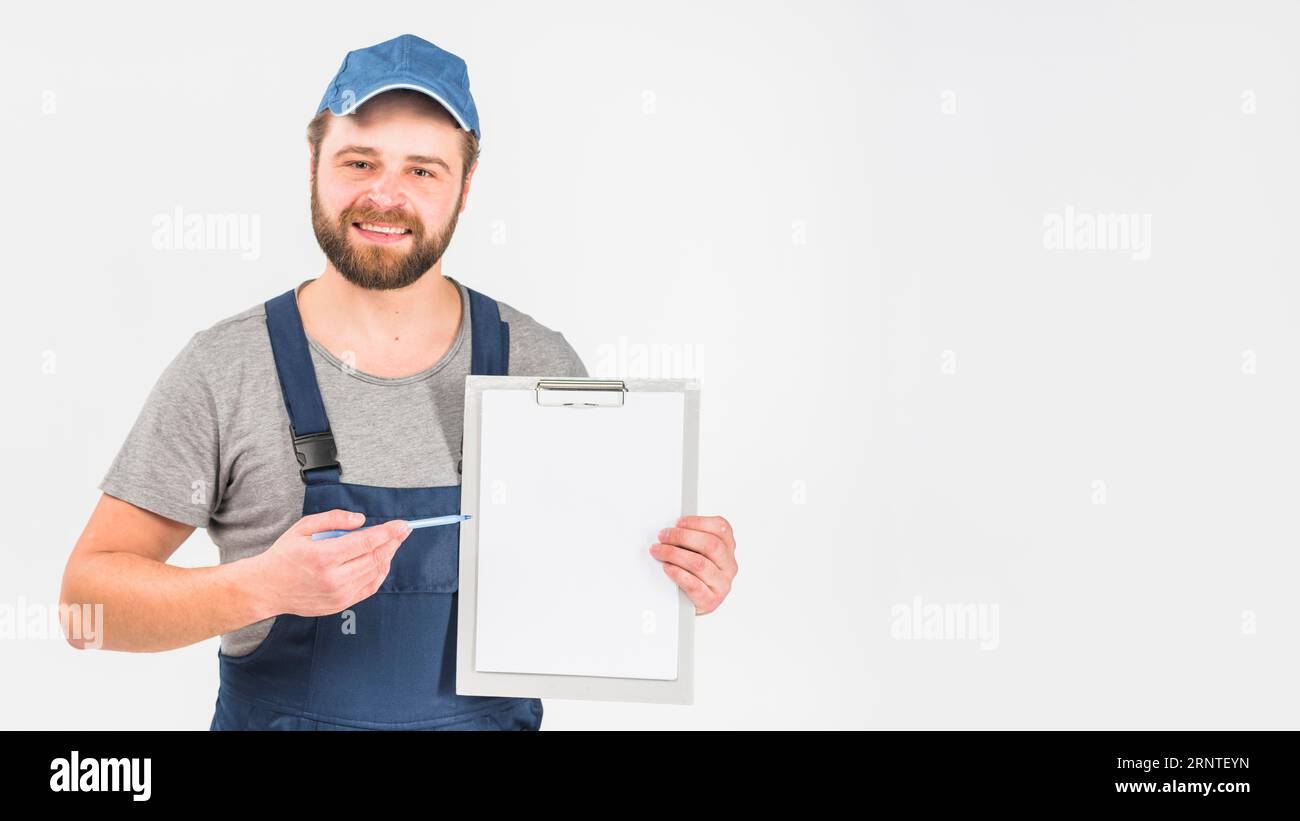 Man overall showing clipboard with paper Stock Photo