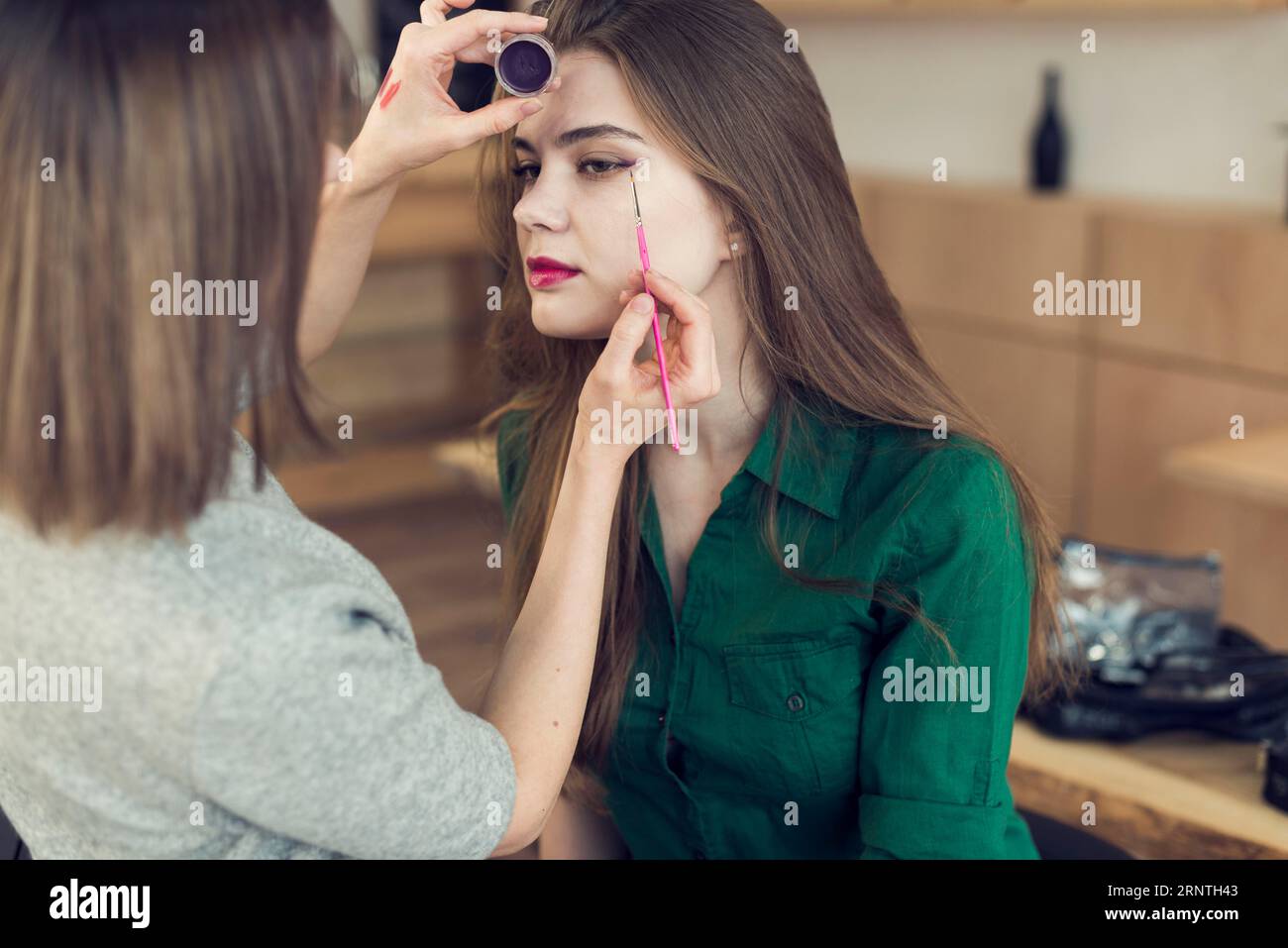 Unrecognizable stylist using eyeliner model Stock Photo