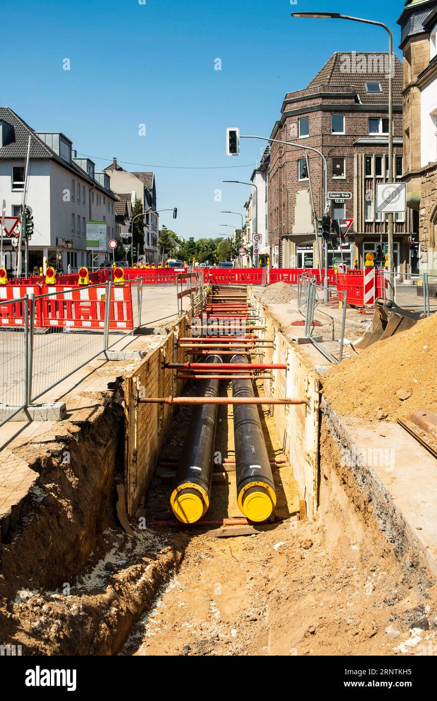 Construction work on a new district heating pipeline for the use of waste heat from an industrial plant in the Benrath district, Duesseldorf, Germany Stock Photo