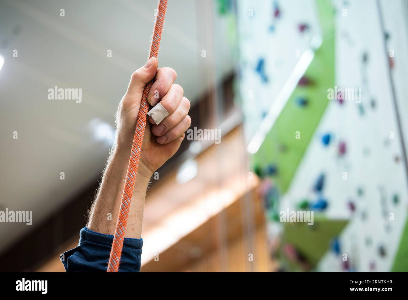 A person holding a rope for belaying in a climbing gym Stock Photo Alamy