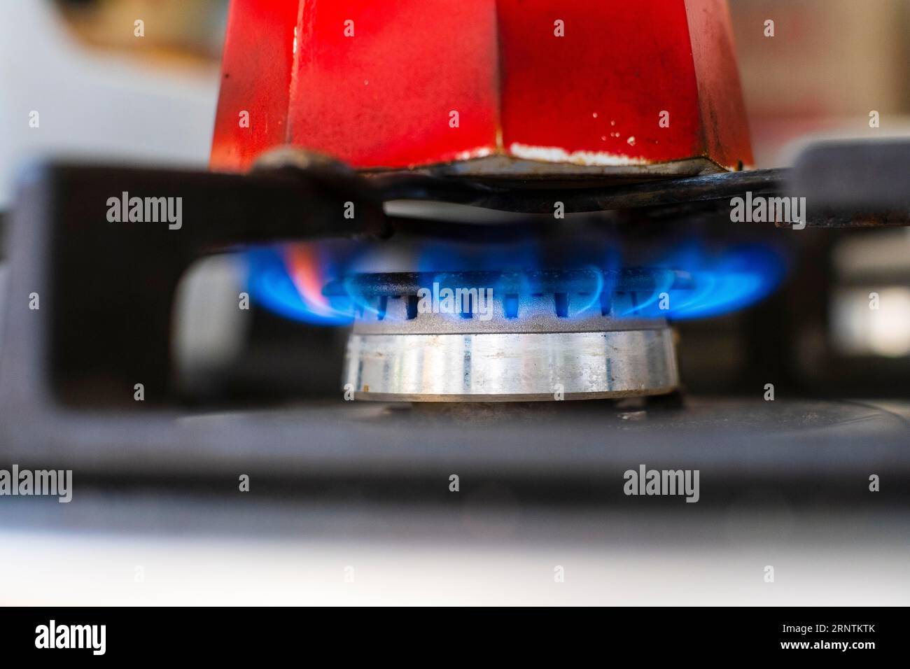 Espresso maker over a flame on a gas cooker Stock Photo