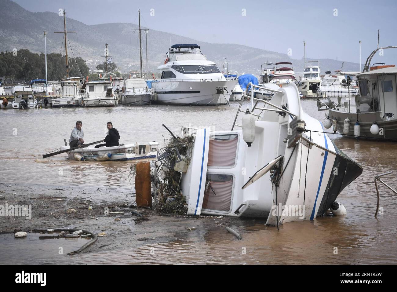 (171115) -- ATHENS, Nov. 15, 2017 -- Locals watch an inverted boat following a heavy rainfall in Mandra, about 20 kilometers west of Athens, capital of Greece, on Nov. 15, 2017. The strong torrential downpour in the municipalities of Mandra, Nea Peramos and Megara, west of the Greek capital, has claimed 15 lives, according to the latest official count by the Health Ministry. ) GREECE-MANDRA-FLOOD MariosxLolos PUBLICATIONxNOTxINxCHN Stock Photo