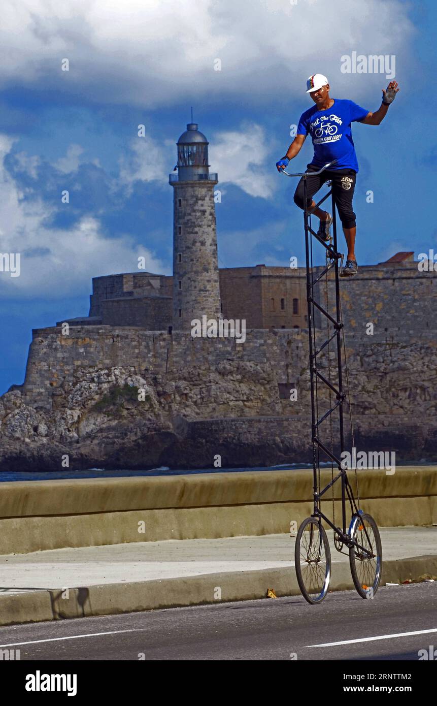 (171119) -- BEIJING, Nov. 19, 2017 -- Felix Guirola rides his giant bicycle in Havana, Cuba, Nov. 11, 2017. Felix Guirola is not afraid of heights as he rides through the streets of Havana on a unique 4-meter bicycle. Guirola has remodeled several bicycles since August 1981, when he pedalled a 2-meter bike at carnivals in the central Cuban city of Ciego de Avila, where he was born 52 years ago. Guirola claims that from 1987 to 2004 he held the world record for the tallest bicycle, but only his neighbors in Ciego de Avila knew about his achievements. ) XINHUA PHOTO WEEKLY CHOICES JOAQUINxHERNAN Stock Photo