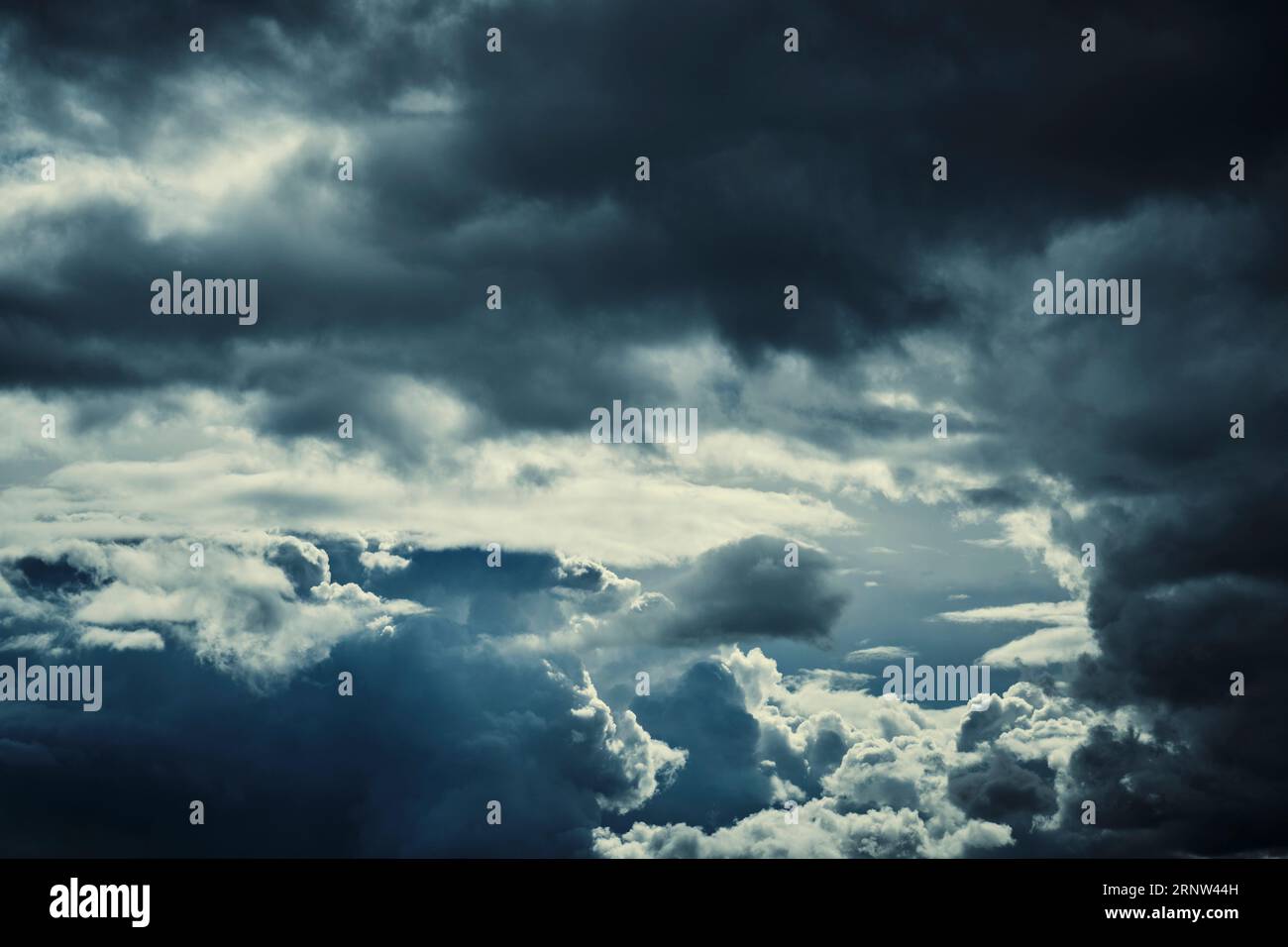 Dark storm clouds with breaking sunlight Stock Photo