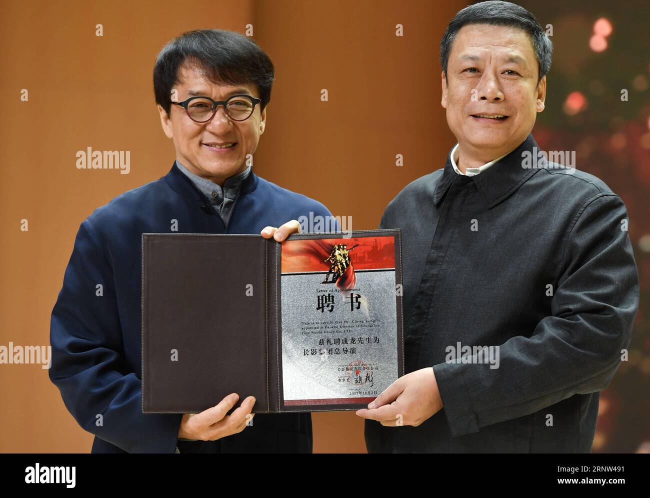 (171203) -- CHANGCHUN, Dec. 3, 2017 -- Movie star Jackie Chan (L) receives the Letter of Appointment to be appointed as General Director of Changchun Film Studio Group in Changchun, capital of northeast China s Jilin Province, Dec. 2, 2017. ) (ry) CHINA-CHANGCHUN-JACKIE CHAN-CEREMONY (CN) XuxChang PUBLICATIONxNOTxINxCHN Stock Photo