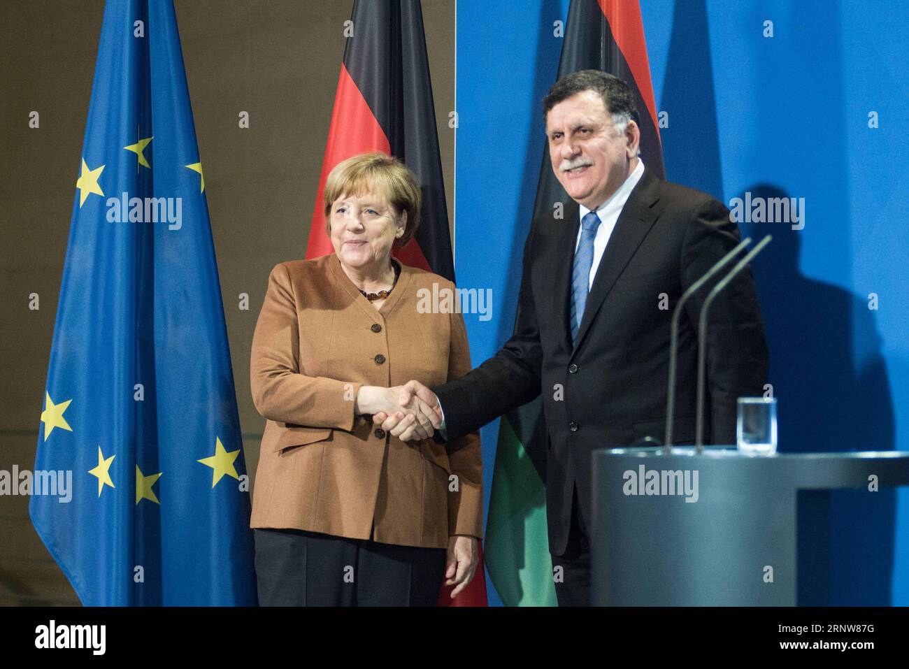 171207 -- BERLIN, Dec. 7, 2017 -- German Chancellor Angela Merkel L shakes hands with visiting Libyan UN-backed Prime Minister Fayez al-Sarraj at a press conference in Berlin, Germany, on Dec. 7, 2017. Merkel, after talks with Fayez al-Sarraj on Thursday, urged the Libyan authorities to improve the conditions of migrants in the North African country and pledged more support from the European Union.  GERMANY-BERLIN-CHANCELLOR-LIBYA-UN-BACKED PM-MEETING ZhangxYuan PUBLICATIONxNOTxINxCHN Stock Photo