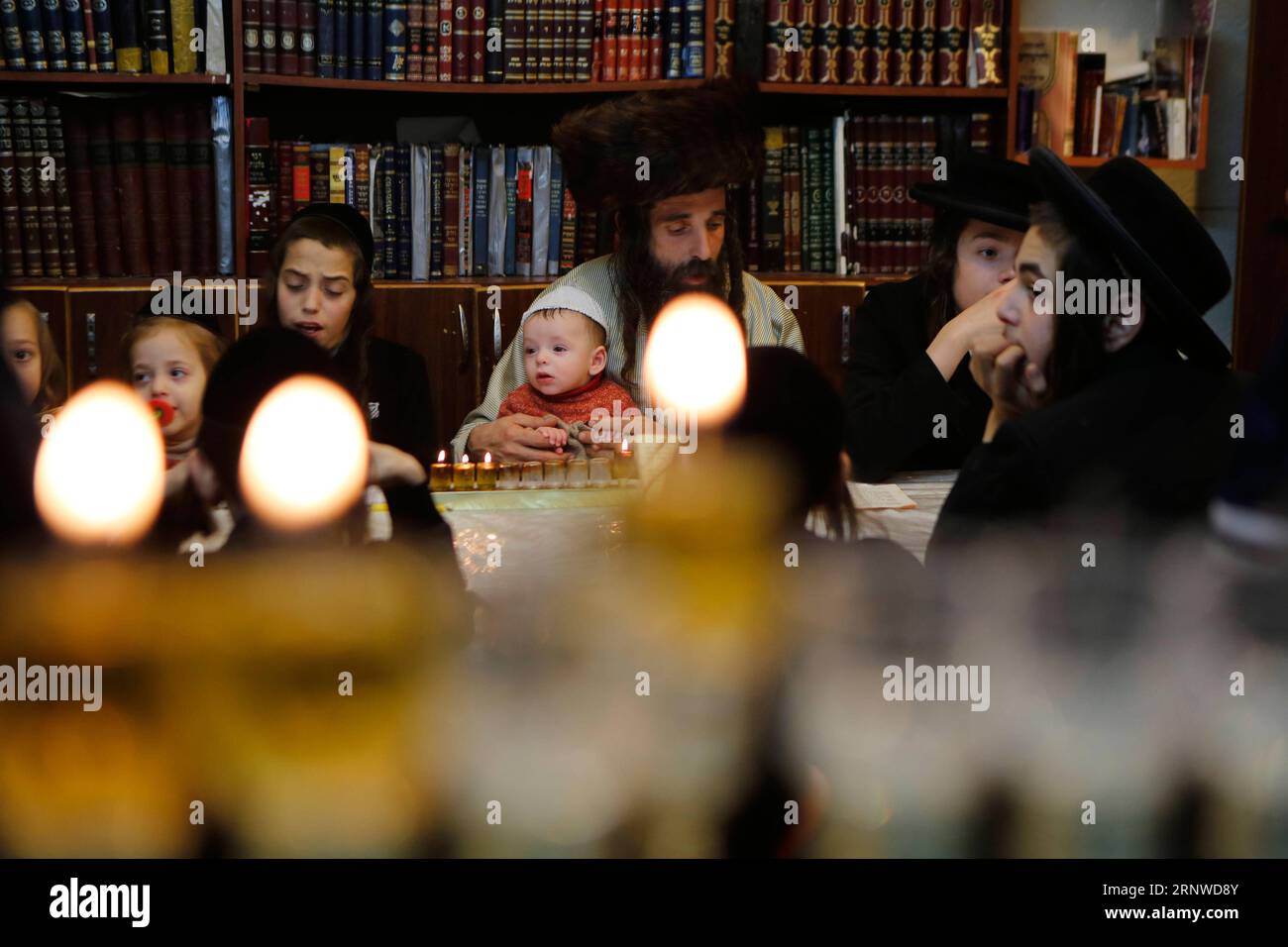(171214) -- JERUSALEM, Dec. 14, 2017 -- Ultra-Orthodox Jews gather during Hanukkah in Mea Shearim neighborhood in Jerusalem, on Dec. 14, 2017. Hanukkah, also known as the Festival of Lights and Feast of Dedication, is an eight-day Jewish holiday commemorating the rededication of the Holy Temple (the Second Temple) in Jerusalem at the time of the Maccabean Revolt against the Seleucid Empire of the 2nd Century B.C. ) MIDEAST-JERUSALEM-HANUKKAH GilxCohenxMagen PUBLICATIONxNOTxINxCHN Stock Photo