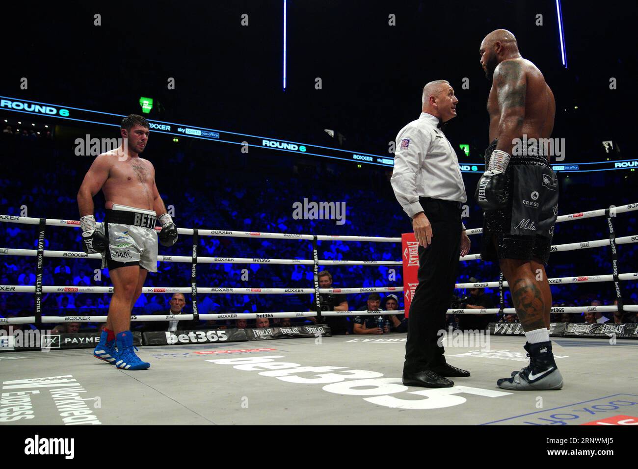 Ring referee speaks to Frazer Clarke (right) after landing a low blow ...