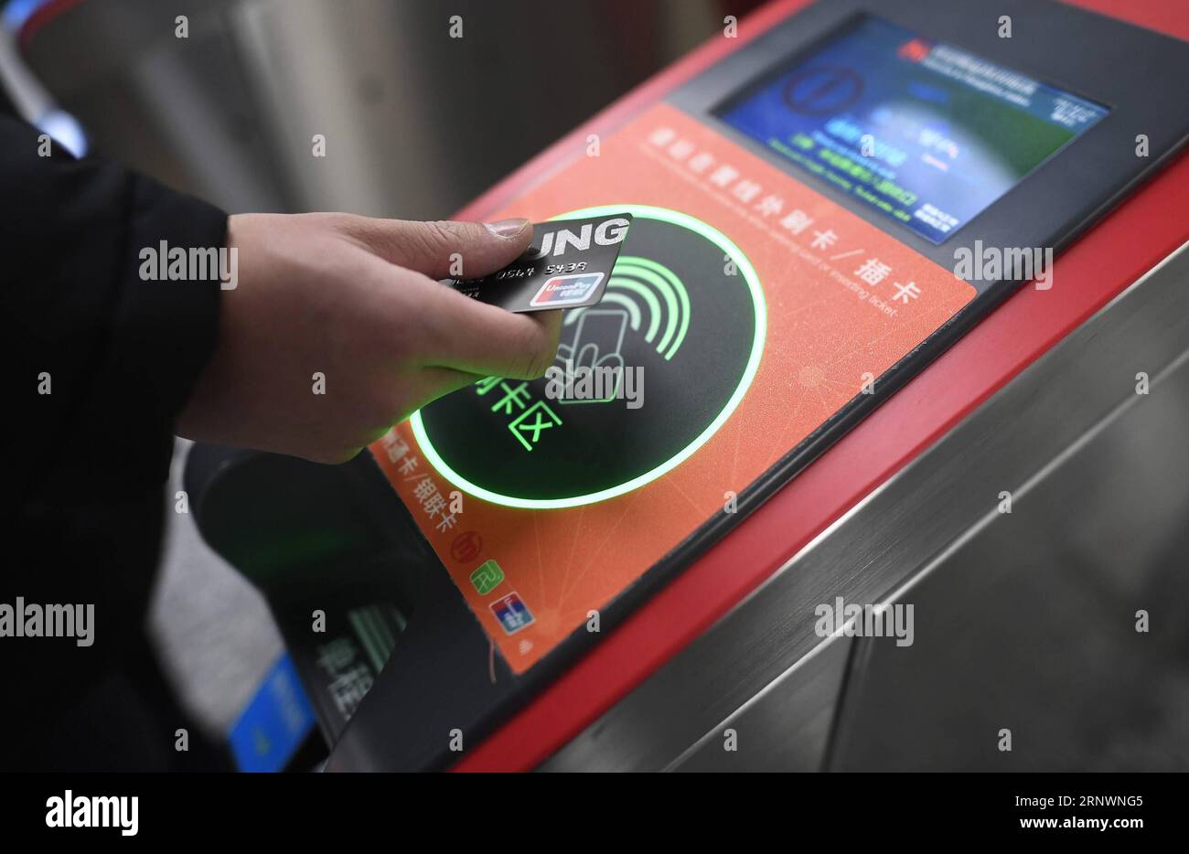 (171227) -- HANGZHOU, Dec. 27, 2017 -- A passenger swipes a UnionPay card to take subway at the Fengtan Road Subway Station in Hangzhou, capital of east China s Zhejiang Province, Dec. 27, 2017. Passengers in Hangzhou no longer need a ticket to take the subway. They can just swipe their smartphones, making Hangzhou the first city in China to realize mobile payments on its subway. Starting from Dec. 27, users of Alipay, a mobile payment app, will get a QR code on their phones, which they can use to enter the electric gates at all 72 subway stations in the city. The price will be deducted from t Stock Photo