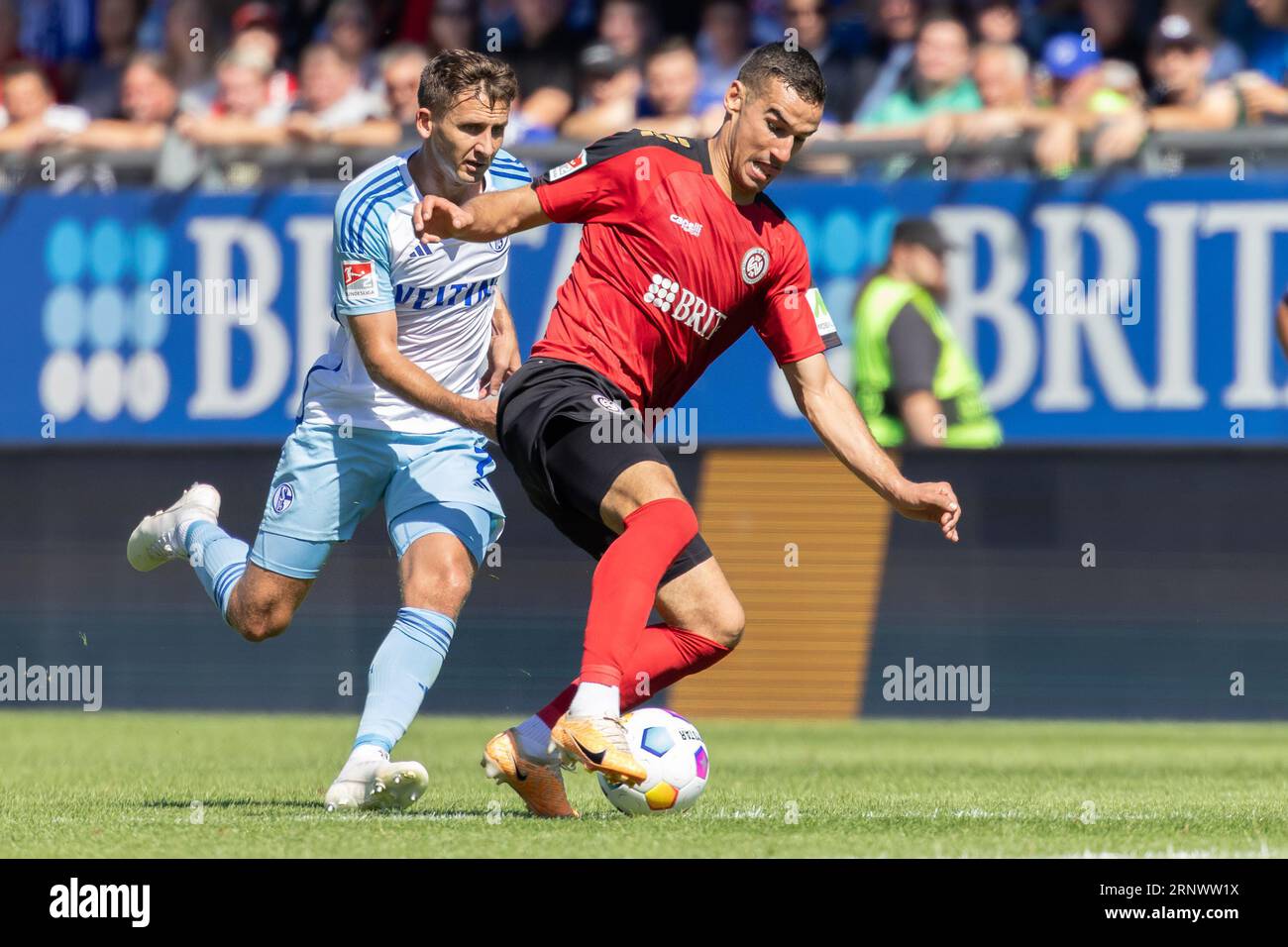 Wiesbaden, Germany. 02nd Sep, 2023. Soccer: 2nd Bundesliga, Matchday 5, SV Wehen Wiesbaden - FC Schalke 04 at BRITA Arena. Ivan Prtajin (r, SV Wehen Wiesbaden, 18) is pursued by Paul Seguin (FC Schalke, 7). Credit: Jürgen Kessler/dpa - IMPORTANT NOTE: In accordance with the requirements of the DFL Deutsche Fußball Liga and the DFB Deutscher Fußball-Bund, it is prohibited to use or have used photographs taken in the stadium and/or of the match in the form of sequence pictures and/or video-like photo series./dpa/Alamy Live News Stock Photo
