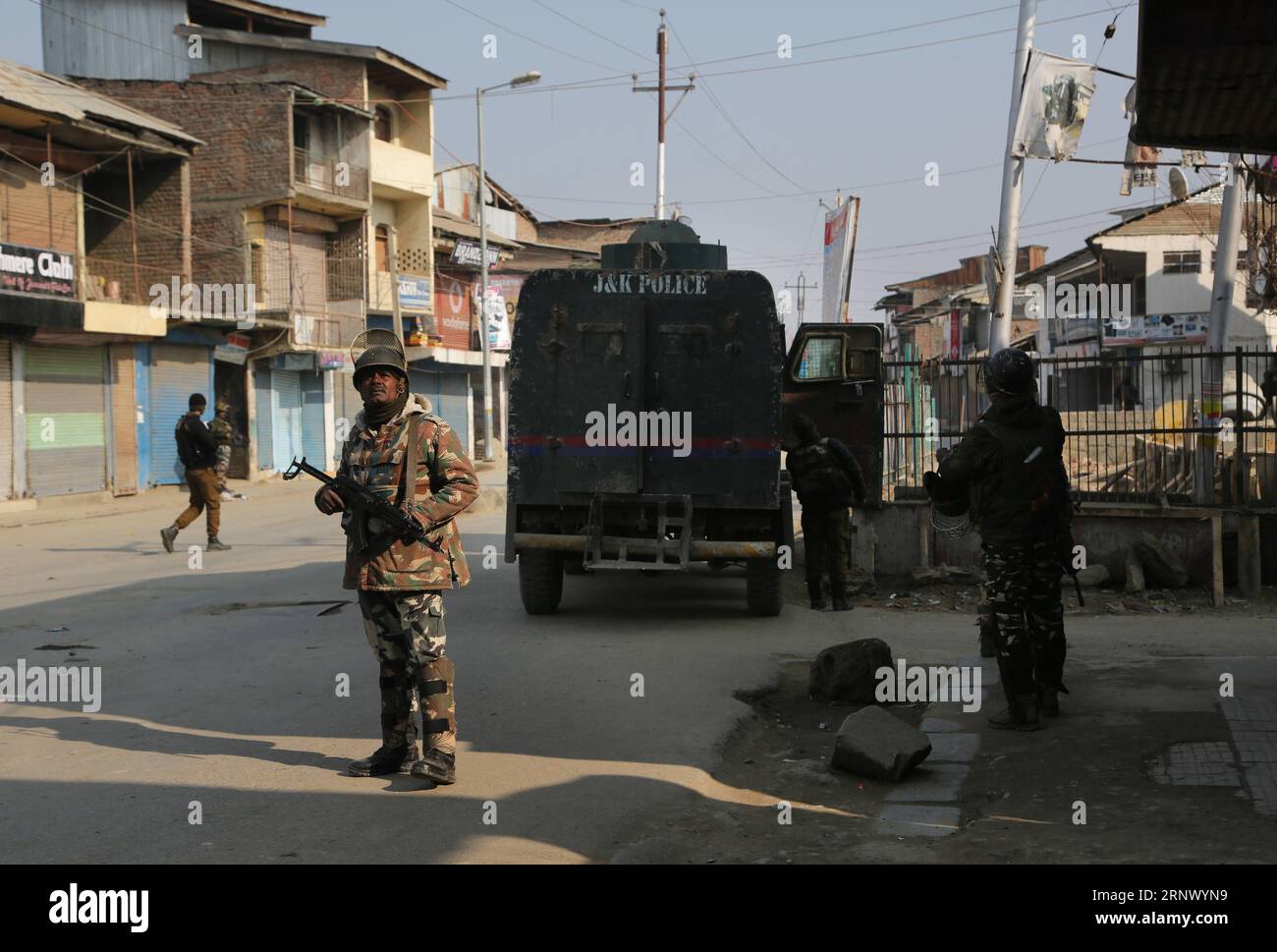 (180106) -- SOPORE, Jan. 6, 2018 -- Indian police and paramilitary troopers stand guard near the site of an improvised explosive device (IED) blast in Sopore town of Baramulla district, about 50 km northwest of Srinagar city, the summer capital of Indian-controlled Kashmir, on Jan. 6, 2018. At least four policemen were killed and two others wounded Saturday after militants triggered an improvised explosive device (IED) blast in restive Indian-controlled Kashmir, police said. ) (whw) INDIAN-CONTROLLED KASHMIR-SOPORE-BLAST JavedxDar PUBLICATIONxNOTxINxCHN Stock Photo