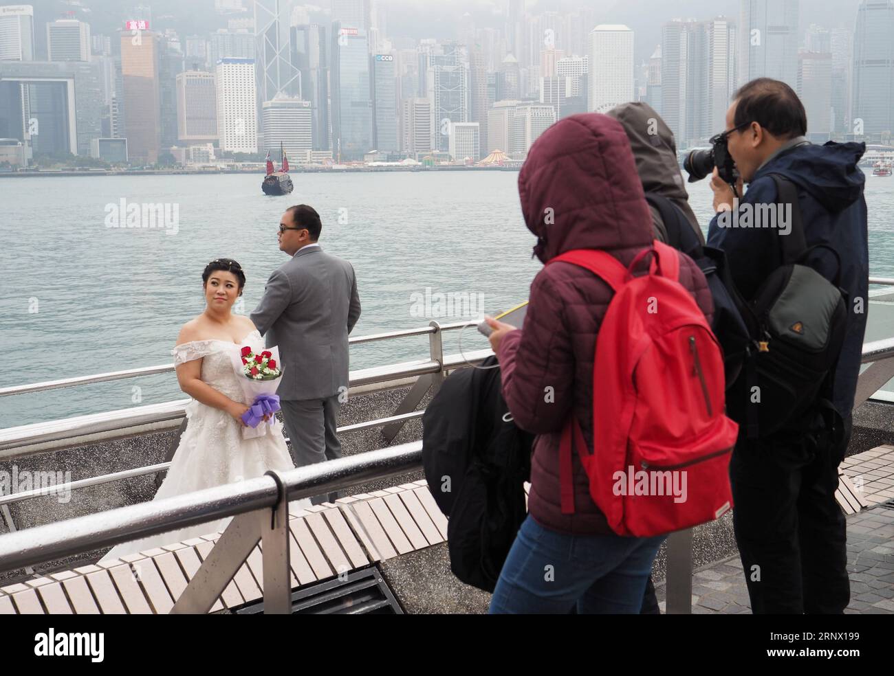 180109) -- HONG KONG, Jan. 9, 2018 -- Citizens take photos on a street in Hong  Kong, south China, Jan. 9, 2018. An intense winter monsoon was bringing  cold weather to south