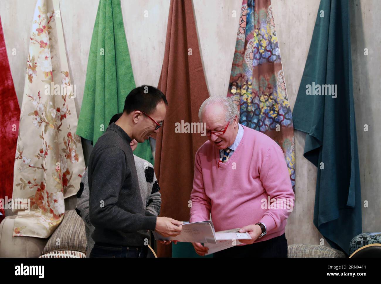 (180112) -- FRANKFURT, Jan. 12, 2018 -- Chinese exhibitors talk with a visitor at a Chinese textile booth at Heimtextil, the world s largest international trade fair for home and contract textiles, in Frankfurt, Germany, on Jan. 11, 2018. A total of 2,975 exhibitors from 64 countries and regions attended the trade fair this year, 545 of which are from China. ) (djj) GERMANY-FRANKFURT-HEIMTEXTIL-CHINA LuoxHuanhuan PUBLICATIONxNOTxINxCHN Stock Photo