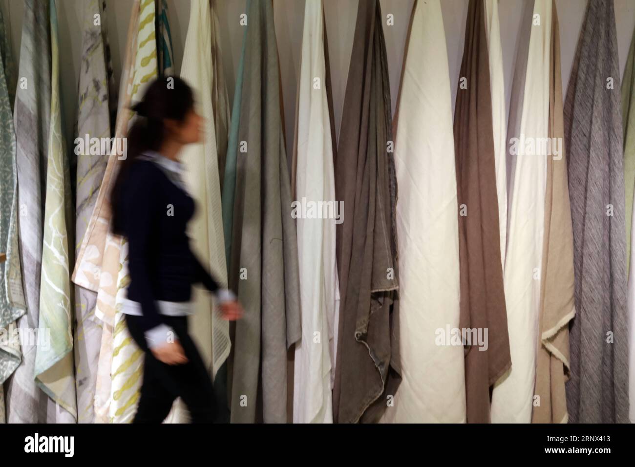 (180112) -- FRANKFURT, Jan. 12, 2018 -- A woman works at a Chinese textile booth at Heimtextil, the world s largest international trade fair for home and contract textiles, in Frankfurt, Germany, on Jan. 11, 2018. A total of 2,975 exhibitors from 64 countries and regions attended the trade fair this year, 545 of which are from China. ) (djj) GERMANY-FRANKFURT-HEIMTEXTIL-CHINA LuoxHuanhuan PUBLICATIONxNOTxINxCHN Stock Photo