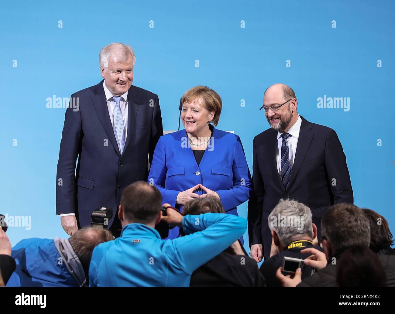 (180112) -- BERLIN, Jan. 12, 2018 -- German Chancellor and leader of German Christian Democratic Union (CDU) Angela Merkel (C), leader of German Christian Social Union (CSU) Horst Seehofer (L) and leader of German Social Democratic Party (SPD) Martin Schulz pose for photos after a joint press conference at the headquarters of SPD, in Berlin, Germany, on Jan. 12, 2018. German Chancellor Angela Merkel s conservatives and the Social Democrats (SPD) on Friday achieved a breakthrough in their exploratory talks aimed at forming a new coalition government, local media reported. )(srb) GERMANY-BERLIN- Stock Photo