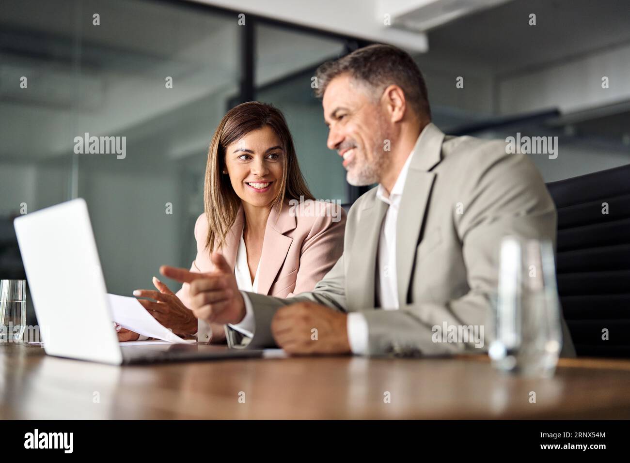 Two Professionals Working Together Two professional business executives working together at office meeting ...
