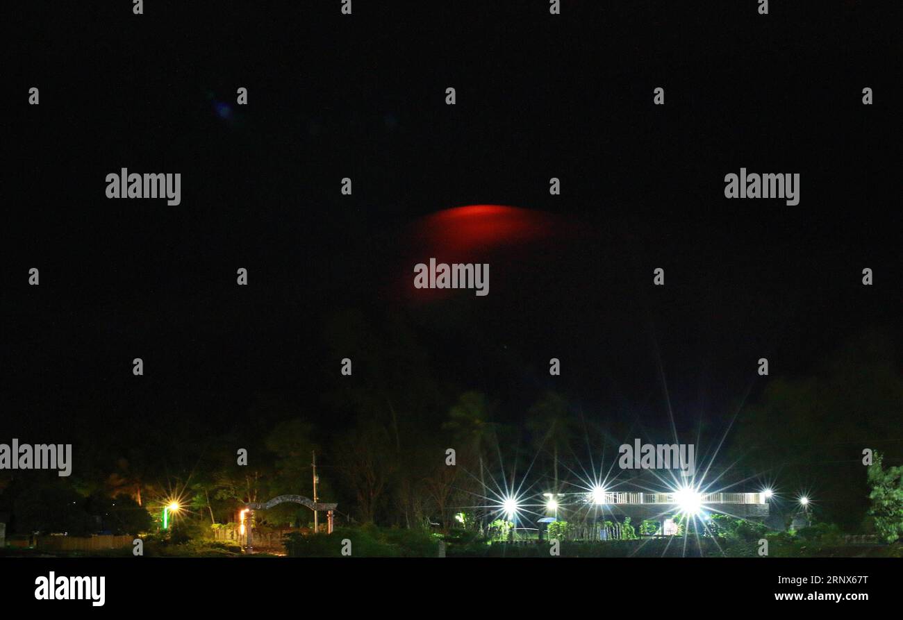 (180114) -- ALBAY, Jan. 14, 2018 () -- An orange glow is seen on the night sky over the Mayon Volcano as it begins to spew lava from its crater in Albay Province, the Philippines, Jan. 14, 2018. Nearly a thousand families living close to the Mayon Volcano evacuated from their homes as Philippine authorities raised its alert level of the Mayon volcano on Sunday for the second time in less than 24 hours from increasing unrest to increased tendency towards eruption within weeks or even days. (/Stringer) (zjy) THE PHILIPPINES-ALBAY-VOLCANO-ALERT Xinhua PUBLICATIONxNOTxINxCHN Stock Photo