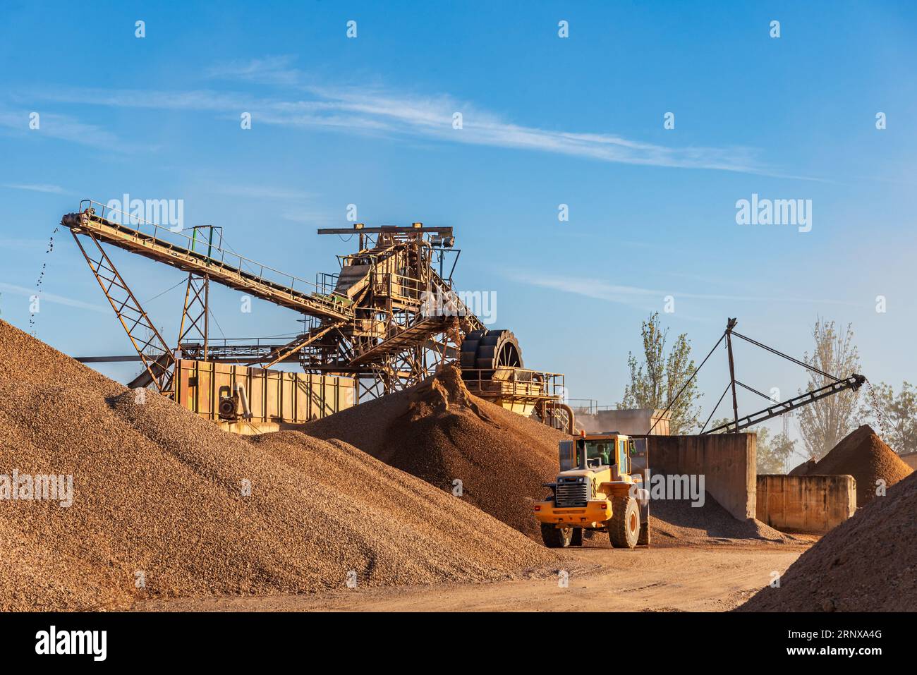 Machinery in a quarry with several conveyor belts to select the different sizes of gravel. Stock Photo