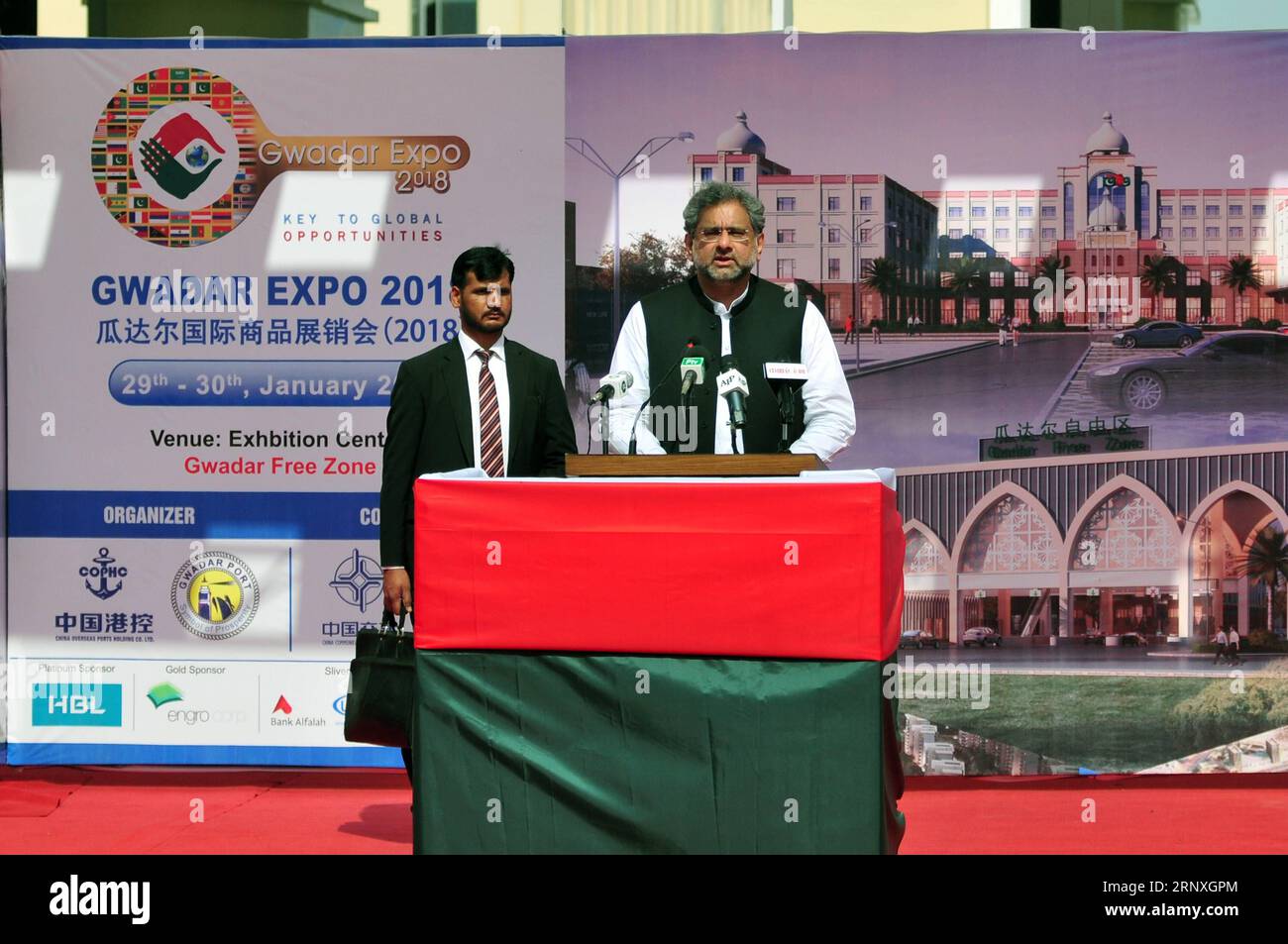 (180129) -- GWADAR, Jan. 29, 2018 -- Pakistani Prime Minister Shahid Khaqan Abbasi (front) addresses during the inauguration ceremony of first phase of Gwadar Port s Free Zone in southwest Pakistan s Gwadar on Jan. 29, 2018. The first phase of Gwadar Port s Free Zone in southwestern Pakistan was inaugurated on Monday by Prime Minister Shahid Khaqan Abbasi, who commented that the free zone would help facilitate regional and global trade under the China-Pakistan Economic Corridor (CPEC). ) (psw) PAKISTAN-GWADAR-FREE ZONE AhmadxKamal PUBLICATIONxNOTxINxCHN Stock Photo