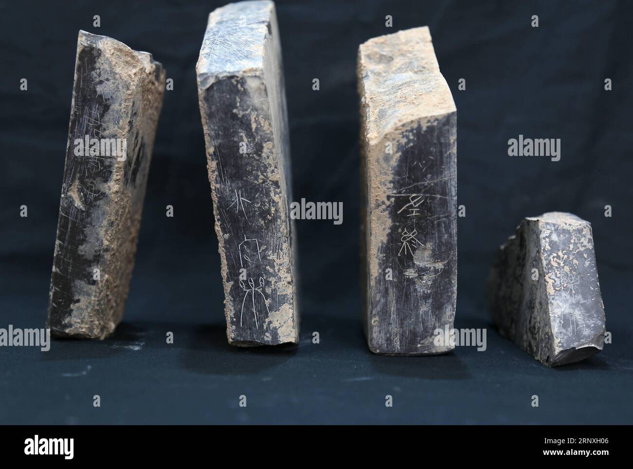 (180129) -- XI AN, Jan. 29, 2018 () -- File photo shows chime debris with inscriptions at the ruins of a government office building, which was believed to be a musical department of the Qin Dynasty (221-207 B.C.), in northwest China s Shaanxi Province. The ruins, 110 meters long and 19.5 meters wide, were composed of four rooms of equal area, with clay walls of around 3 meters thick, said Zhang Yanglizheng, assistant researcher with the provincial research institute of archaeology. In addition to architecture materials, such as tiles and bricks, pieces of stone chimes, a percussion instrument Stock Photo