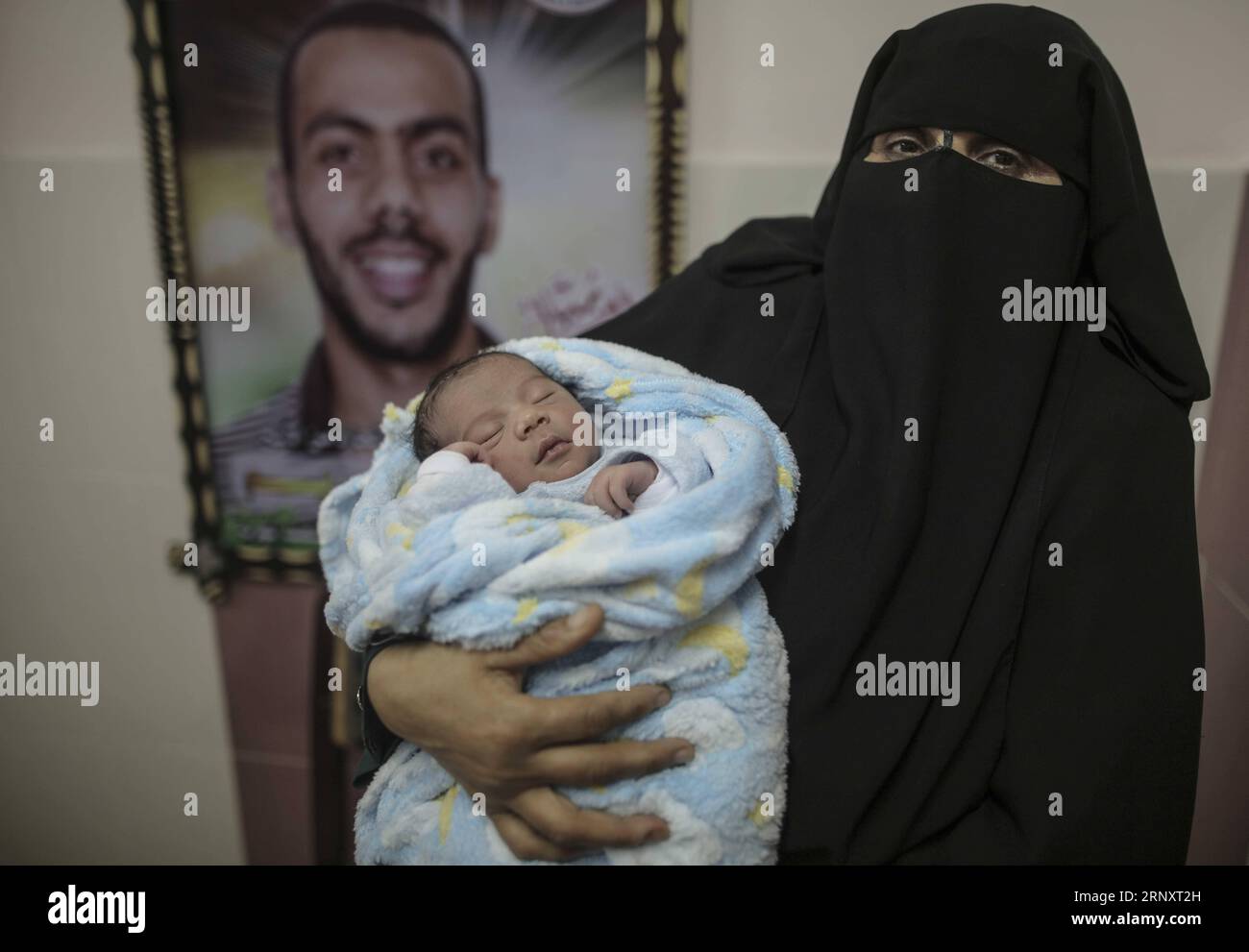 (180211) -- GAZA, Feb. 11, 2018 -- A Palestinian woman holds her newborn baby inside a hospital in Gaza City, on Feb. 11, 2018. The test-tube baby, named Mujahid, has been born with the smuggled sperm of his father who has been sentenced for seven years in Israeli jail. Many Palestinian women with husbands serving long terms in Israeli jails have resorted to sneaking sperm out and getting pregnant. ) MIDEAST-GAZA-SPERM SMUGGLING WissamxNassar PUBLICATIONxNOTxINxCHN Stock Photo