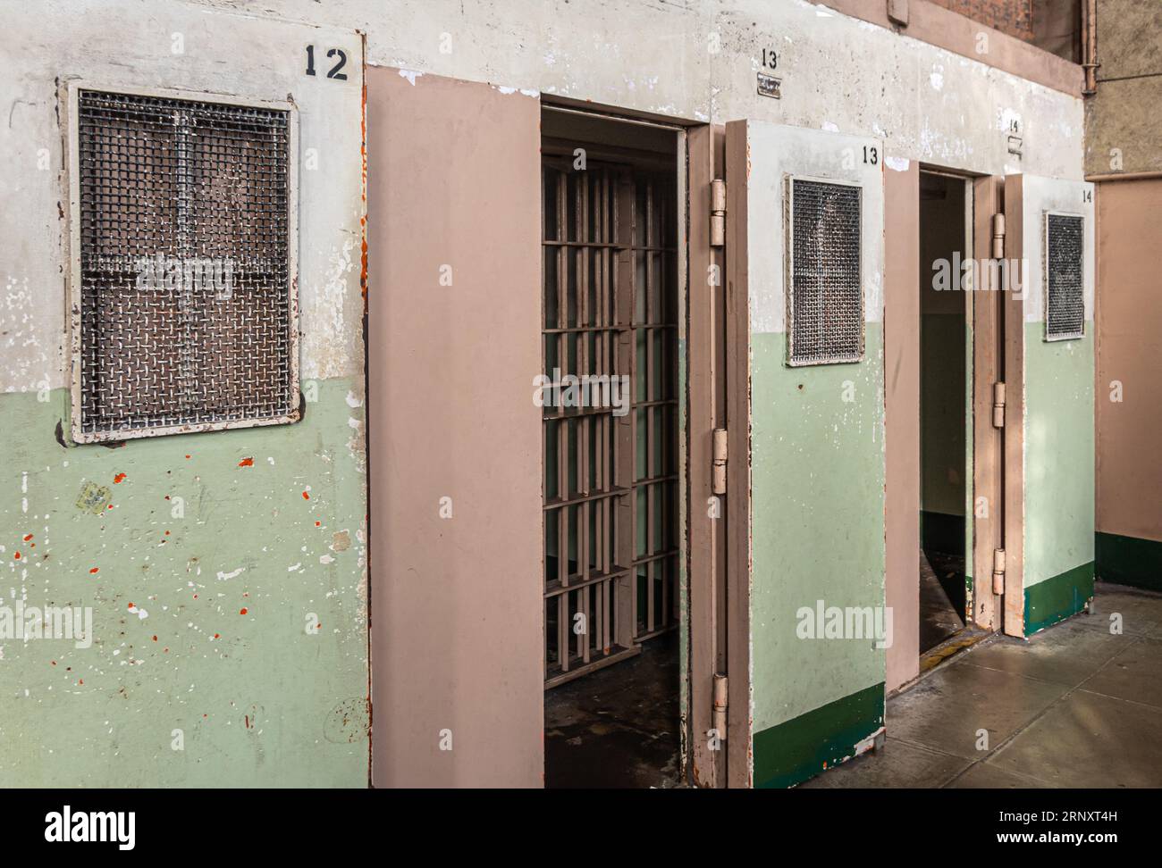 San Francisco, CA, USA - July 12, 2023: Inside historic Alcatraz prison. Solitary cell entrances with double enclosures, metal grid and full doors Stock Photo