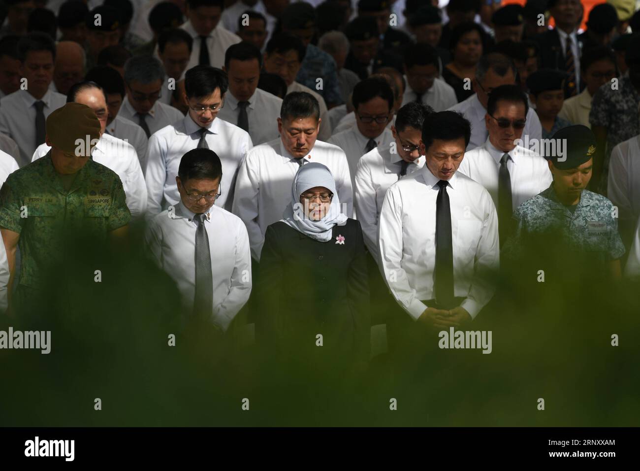 (180215) -- SINGAPORE, Feb. 15, 2018 -- Singapore s President Halimah Yacob (Front C) attends an one-minute of silence during the war memorial service held at the War Memorial Park in Singapore on Feb. 15, 2018. Singapore Thursday held the 51st War Memorial Service in commemoration of the civilian victims of the Japanese Occupation and Total Defence Day Commemoration event. ) (zf) SINGAPORE-WAR-MEMORIAL-JAPANESE OCCUPATION ThenxChihxWey PUBLICATIONxNOTxINxCHN Stock Photo