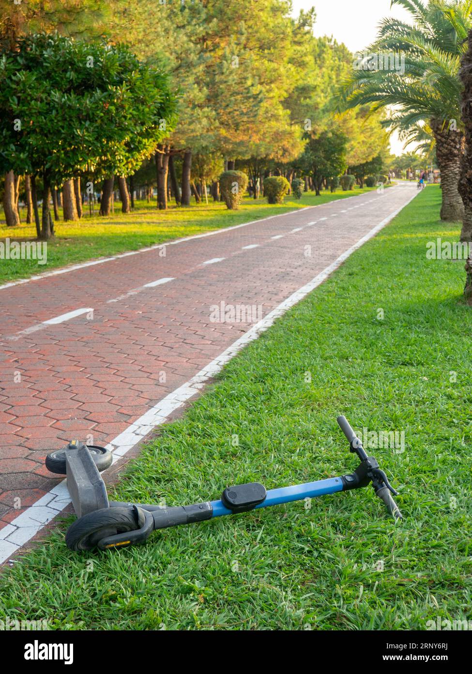 Bike lane concept. Healthy lifestyle. Urban space in a modern resort.  electric scooter is lying on the track. accident concept. Road for sports. Stock Photo