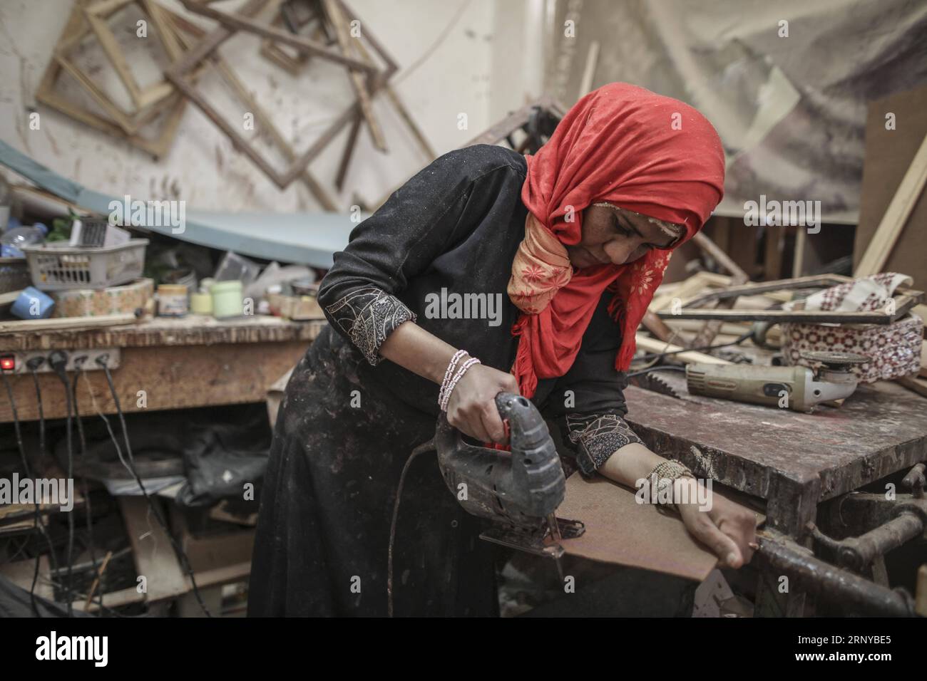 (180308) -- GAZA, Mar. 8, 2018 - Palestinian woman Amal Regaeg, 40, is seen working inside her carpentry shop, in al-Nusairat refugee camp, in the central Gaza Strip, on the International Women s Day, on Mar. 8, 2018. Regaeg has founded the shop and she started working as the first female carpenter in Gaza 10 years ago. Wissam Nassar) MIDEAST-GAZA-MARKET-WOMAN-DAY zhaoyue PUBLICATIONxNOTxINxCHN Stock Photo