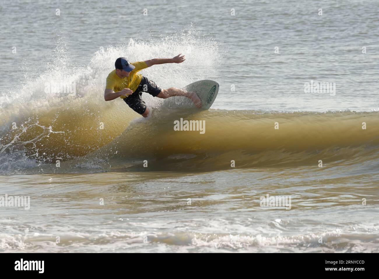 Male contestant rides for points during heat at the Zap Pro/Am Championships of Skimboarding, August 11, 2023, Dewey Beach, Delaware USA. Stock Photo