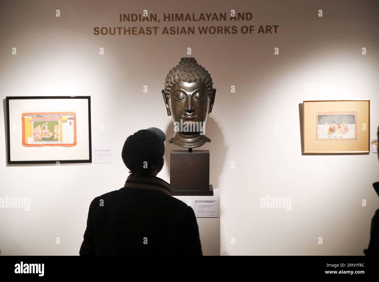 (180316) -- NEW YORK, March 16, 2018 -- A visitor looks at a large bronze head of Buddha of Thailand during the public viewing of Christie s Asian Art Week in New York, the United States, on March 16, 2018. Christie s on Friday kicked off its Asian Art Week, a series of auctions, viewings, and events, from March 16 to March 23. This season presents six distinct auctions including Fine Chinese Ceramics and Works of Art, South Asian Modern + Contemporary Art, etc. ) U.S.-NEW YORK-CHRISTIE S-ASIAN ART WEEK WangxYing PUBLICATIONxNOTxINxCHN Stock Photo