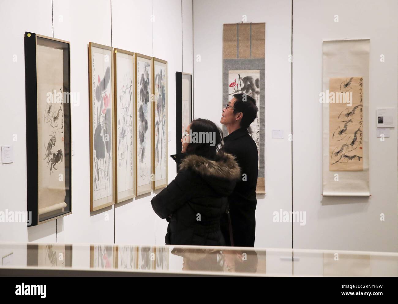 (180316) -- NEW YORK, March 16, 2018 -- Visitors look at artworks of Chinese artist Qi Baishi during the public viewing of Christie s Asian Art Week in New York, the United States, on March 16, 2018. Christie s on Friday kicked off its Asian Art Week, a series of auctions, viewings, and events, from March 16 to March 23. This season presents six distinct auctions including Fine Chinese Ceramics and Works of Art, South Asian Modern + Contemporary Art, etc. ) U.S.-NEW YORK-CHRISTIE S-ASIAN ART WEEK WangxYing PUBLICATIONxNOTxINxCHN Stock Photo