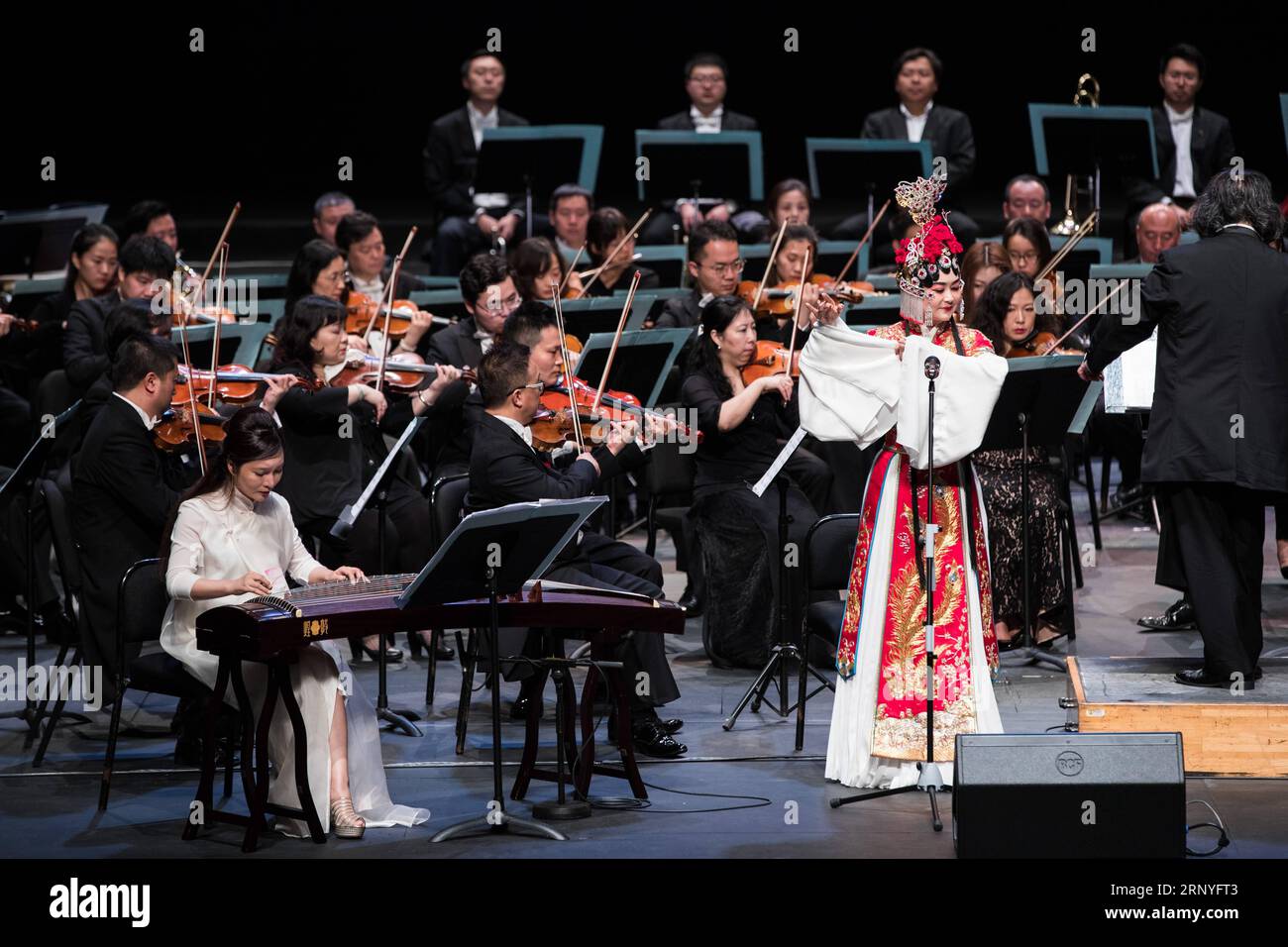 (180318) -- KUALA LUMPUR, March 18, 2018 -- Soprano Chen Junhua (R front), guzheng player Ji Wei (L front) and musicians of China National Symphony Orchestra perform during the Belt and Road Malaysia-China friendship piano symphony concert in Istana Budaya in Kuala Lumpur, Malaysia, March 17, 2018. ) (psw) MALAYSIA-KUALA LUMPUR-CHINA-CONCERT ZhuxWei PUBLICATIONxNOTxINxCHN Stock Photo
