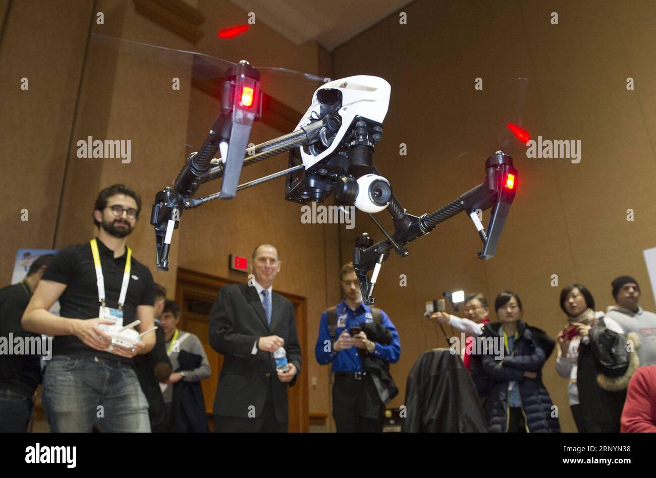 (180327) -- BEIJING, March 27, 2018 -- Representatives from Chinese DJI company show Inspire 1 quadcopter during the preview media show of The Consumer Electronics Show (CES) in Las Vegas, the United States, Jan. 4, 2015. A huge trade deficit with China is reportedly behind the U.S. administration s plan to slap tariffs on up to 60 billion U.S. dollars of Chinese imports and restrict Chinese investment. But data sometimes lies, and could shield the bigger picture. ) (djj) Xinhua Headlines: Truth behind China-U.S. trade imbalances YangxLei PUBLICATIONxNOTxINxCHN Stock Photo