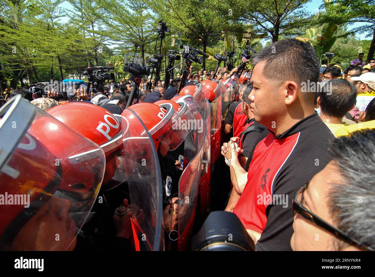 (180328) -- KUALA LUMPUR, March 28, 2018 -- Police stand guard as protesters hold a gathering outside the Parliament in Kuala Lumpur, Malaysia, March 28, 2018. The Malaysian parliament on Wednesday passed a motion to redraw the electoral map, as both the ruling Barisan Nasional (BN) coalition and the opposition parties are gearing up to contest the 222 seats nationwide in a general election expected to take place in the next few weeks. Hundreds of protesters, including Mahathir Mohamad, a former prime minister-turned opposition leader, gathered outside the Parliament in Kuala Lumpur on Wednesd Stock Photo