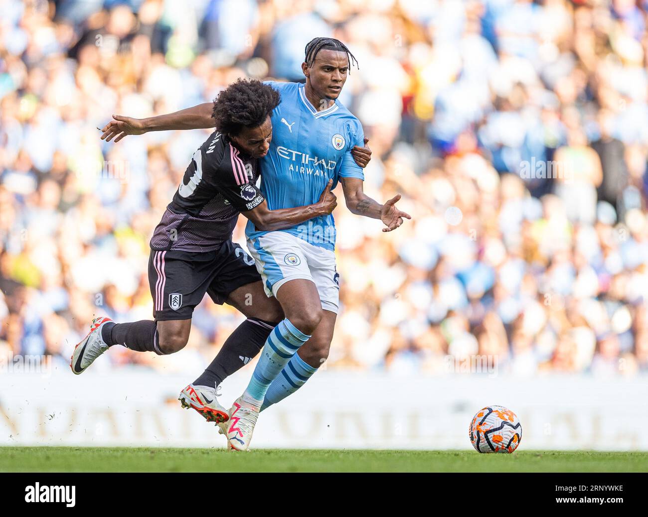 Manchester, UK. 3rd Sep, 2023. Fulham's Willian Borges da Silva (L) challenges Manchester City's Manuel Akanji during the English Premier League match between Manchester City FC and Fulham FC in Manchester, Britain, on Sept. 2, 2023. Credit: Xinhua/Alamy Live News Stock Photo