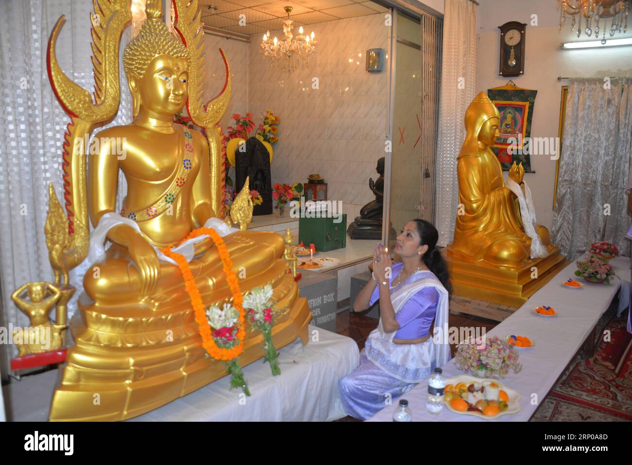 (180429) -- DHAKA, April 29, 2018 () -- A woman prays in front of a big statue of Buddha during Buddha Purnima celebration in Dhaka, Bangladesh on April 29, 2018. Bangladesh s Buddhist community Sunday celebrated Buddha Purnima , in a befitting manner, which marks holy Gautama Buddha s birth, enlightenment and death. () (wtc) BANGLADESH-DHAKA-BUDDHA-FESTIVAL xinhua PUBLICATIONxNOTxINxCHN Stock Photo