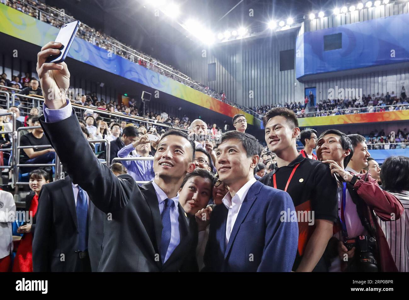 (180504) -- BEIJING, May 4, 2018 -- Peking University (PKU) alumnus Li Yanhong (R, front), who is also chair and CEO of China s Internet giant Baidu, poses for a selfie with others after a ceremony marking the 120th anniversary of the university at the Peking University Khoo Teck Puat Gymnasium in Beijing, capital of China, May 4, 2018. ) (lmm) CHINA-BEIJING-PEKING UNIVERSITY-120TH ANNIVERSARY (CN) ShenxBohan PUBLICATIONxNOTxINxCHN Stock Photo