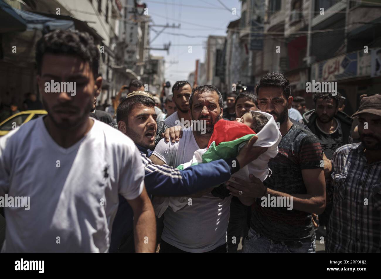 (180515) -- GAZA, May 15, 2018 -- Mourners and relatives carry the body of eight-month-old Palestinian infant Laila al-Ghandour, who died after inhaling tear gas during a protest at the Israel-Gaza border in Gaza City, on May 15, 2018. On Monday, Israeli forces shot dead dozens of Palestinians and injured more than 2,000 others in a day-long confrontation along the Gaza strip-Israel border. Wissam Nassar) (dtf) MIDEAST-GAZA-FUNERAL YangxYuanyuan PUBLICATIONxNOTxINxCHN Stock Photo