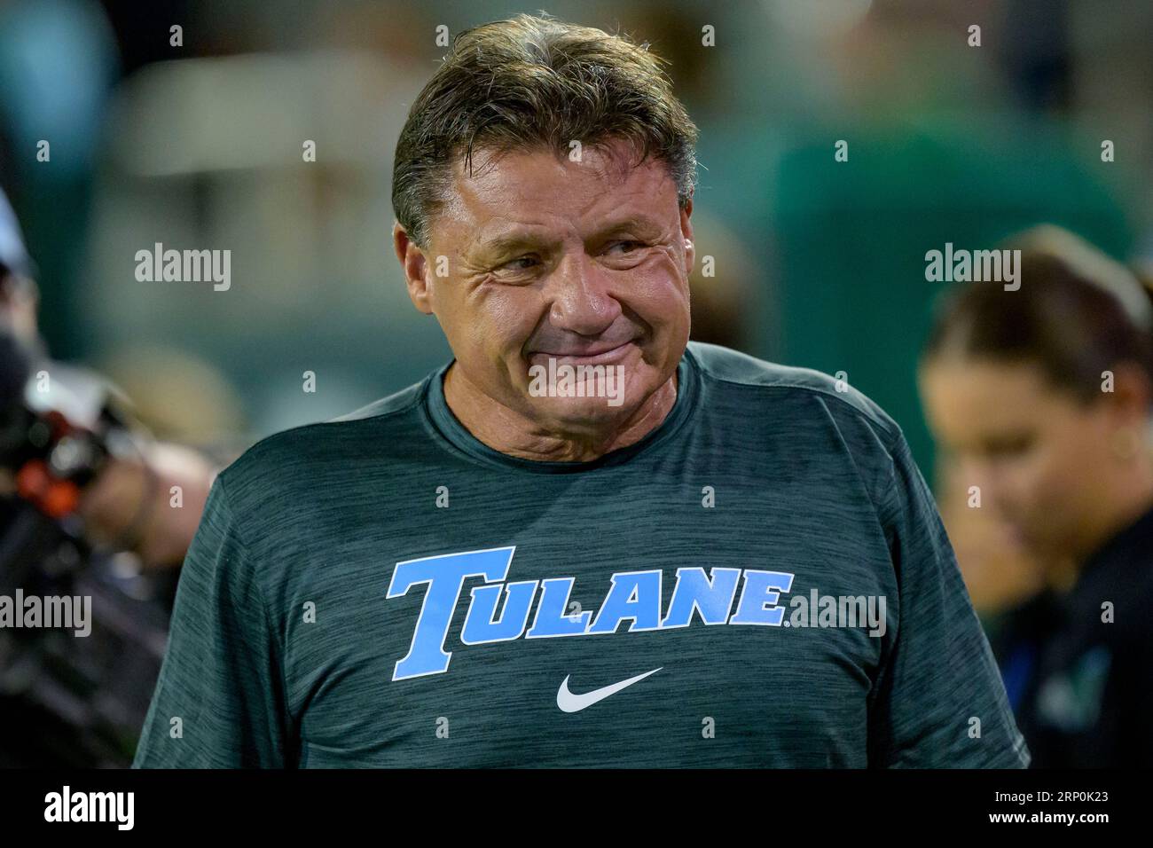 Former LSU head coach Ed Orgeron wears a Tulane shirt as he watches the