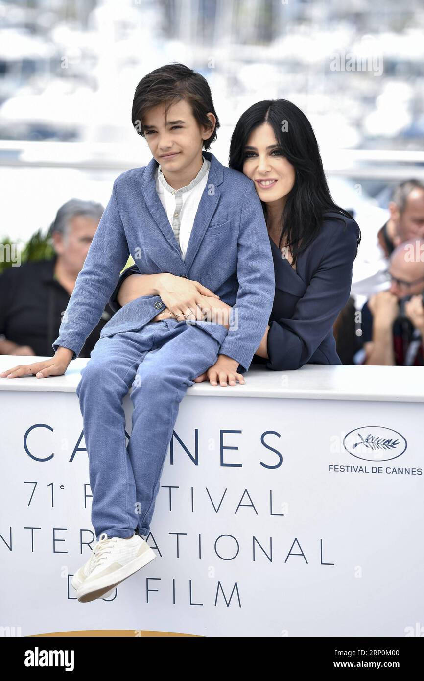 (180518) -- CANNES, May 18, 2018 -- Actor Zain Al Rafeea (L) and director Nadine Labaki of the film Capernaum , pose during a photocall of the 71st Cannes International Film Festival in Cannes, France on May 18, 2018. The 71st Cannes International Film Festival is held from May 8 to May 19. ) (wtc) FRANCE-CANNES-71ST INTERNATIONAL FILM FESTIVAL-CAPERNAUM-PHOTOCALL ChenxYichen PUBLICATIONxNOTxINxCHN Stock Photo