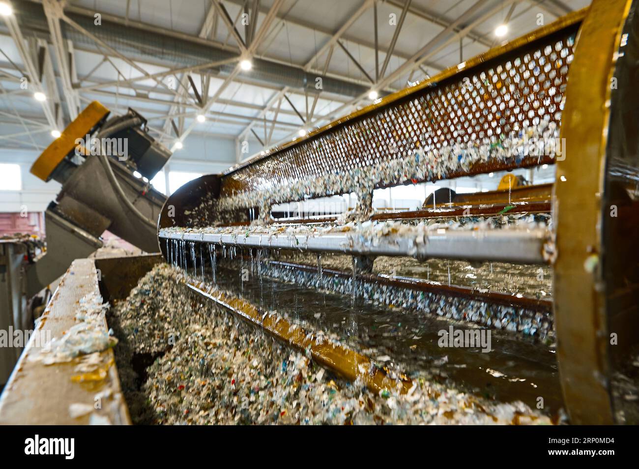 Automatic shredded plastic washing machine. Washing in a bath of water