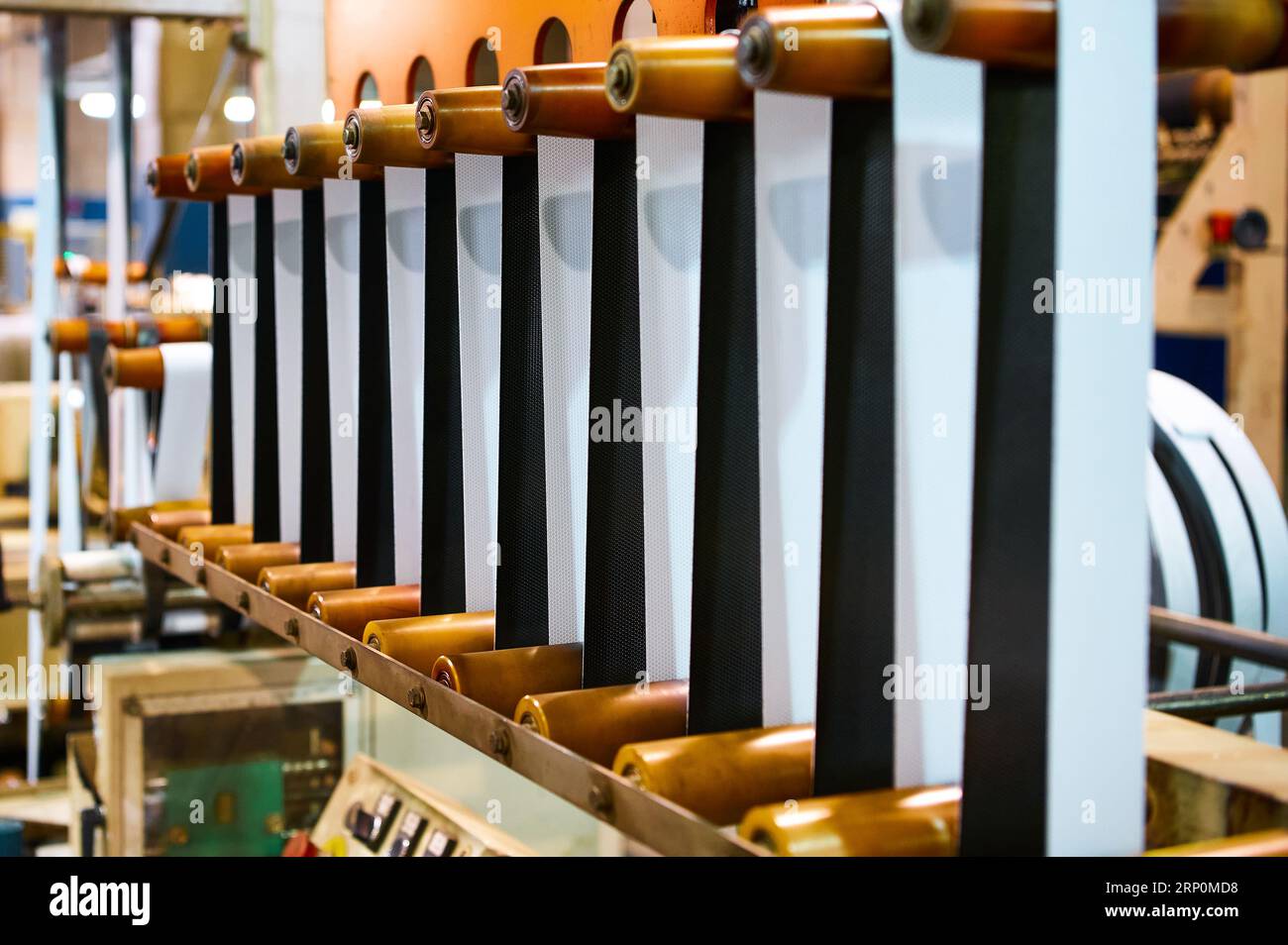 Long strip of rubber reinforced with textile in workshop Stock Photo