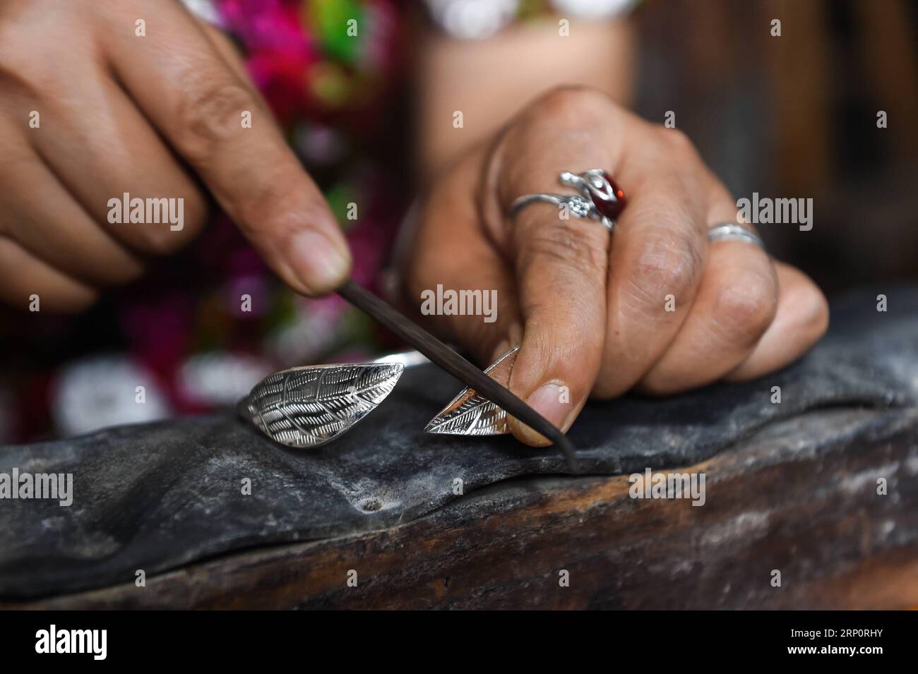 (180523) -- KAILI, May 23, 2018 -- Yang Changlan polishes silverwork in Hongxi Village in Wanshui Township of Kaili, southwest China s Guizhou Province, May 22, 2018. The 36-year-old Yang Changlan has engaged in silverwork making for 12 years. In 2017, Yang and her husband founded a silverwork cooperative and helped other villagers to increase income. )(mcg) CHINA-GUIZHOU-KAILI-SILVERSMITH (CN) TaoxLiang PUBLICATIONxNOTxINxCHN Stock Photo